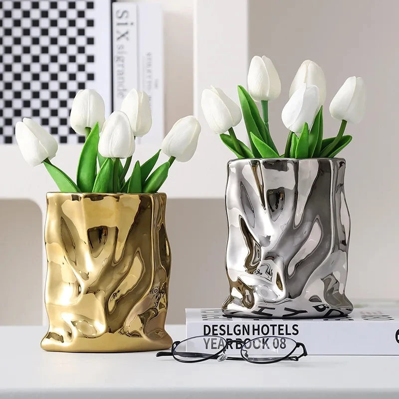 Gold and Silver Vases standing on a book