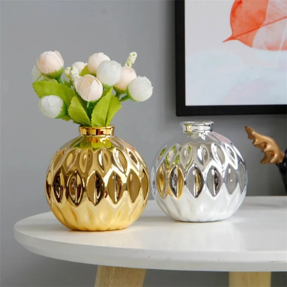 Gold and Silver Vases next to each other on a white table