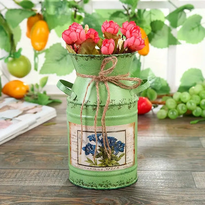 Green Metal Vase on a wooden table with red flowers inside