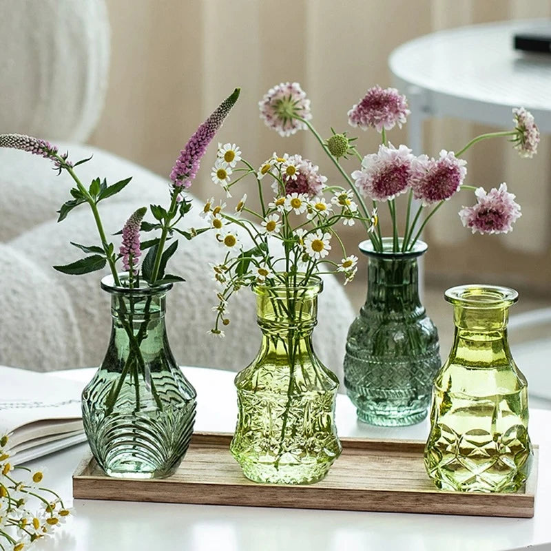 Four Green Small Vases on a wooden tray with flowers inside