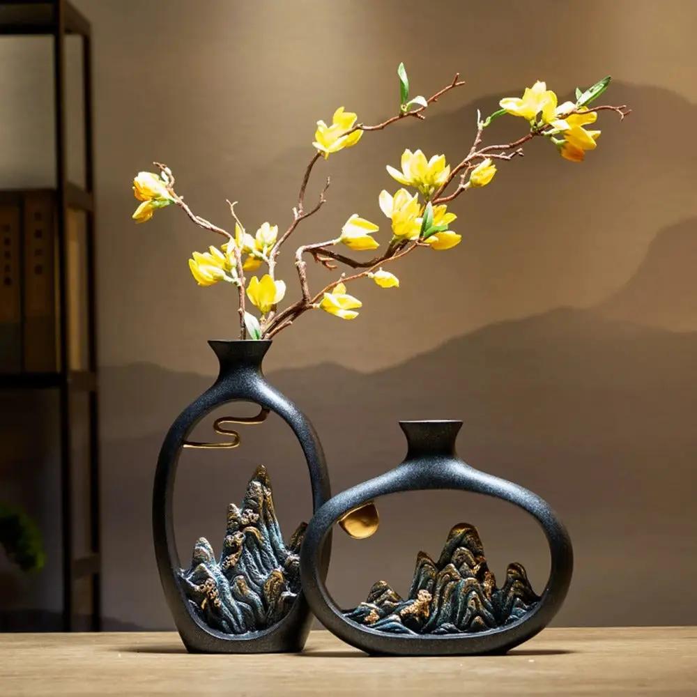 Two Japanese Black Vases With Flowers Inside