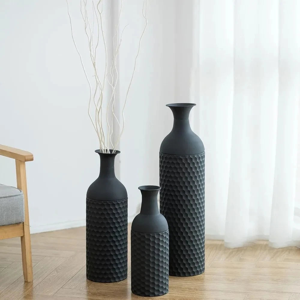 Large Black Vase set in front of white curtains on a wooden floor