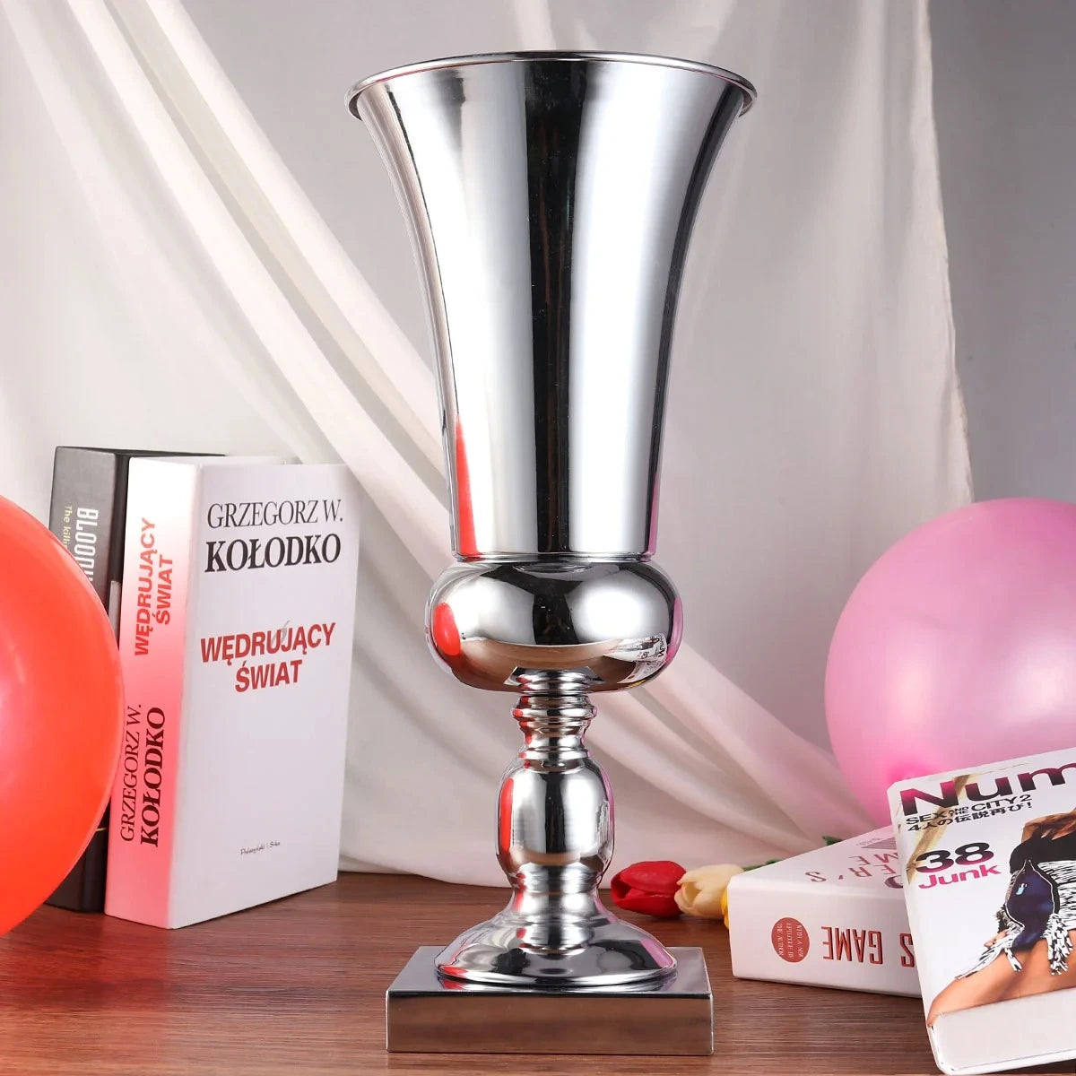 Large Silver Vase next to books on a wooden table