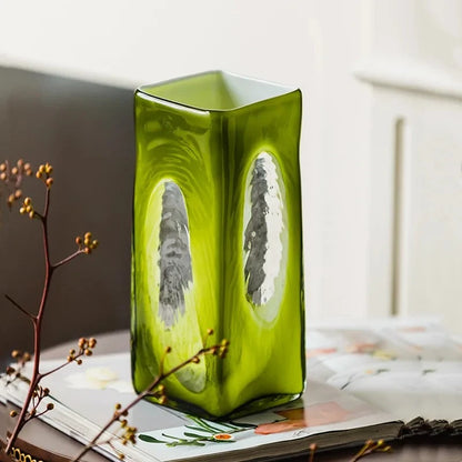 Lime Green Vase on a wooden table next to magazines