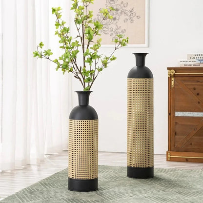 Two Metal Floor Vases with greenery inside on a carpet