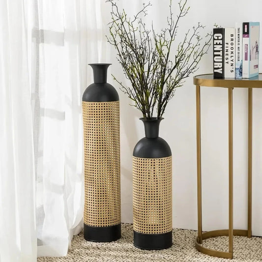 Two Metal Floor Vases on next to a golden table with books on it