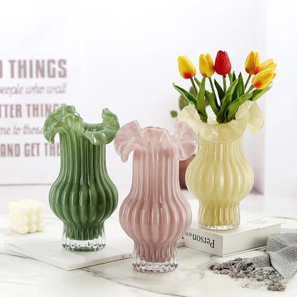 Three Milk Glass Bud Vases with flowers inside on a table with decoration