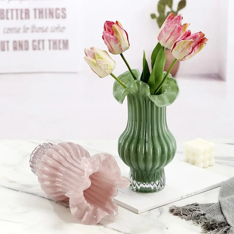 Two Milk Glass Bud Vases with flowers inside next to decorational elements