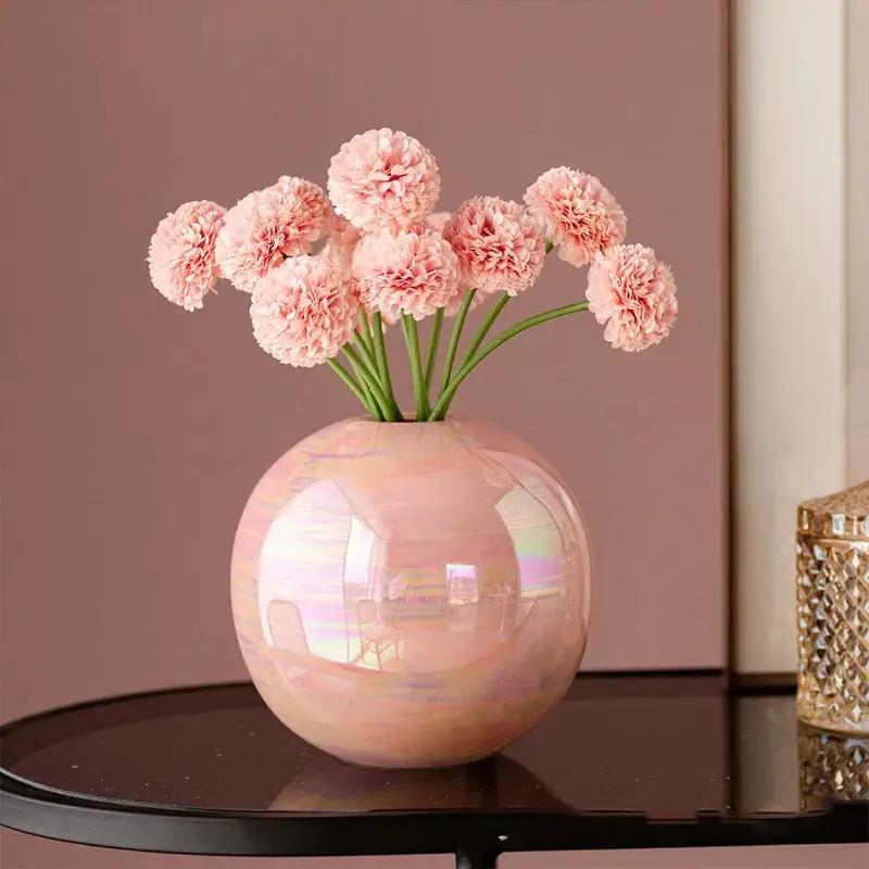 Pink Bud Vase standing on a black table with pink flowers inside