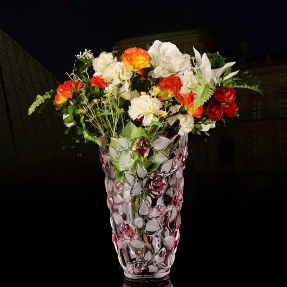 Pink Crystal Vase on a shiny black surface with flowers inside