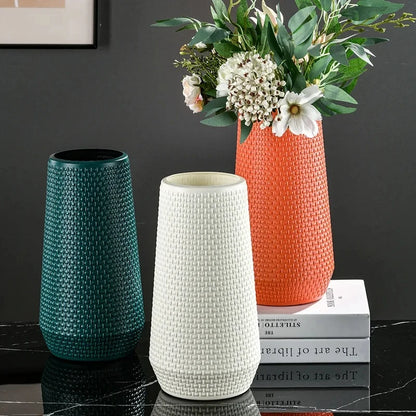 Three Plastic Cylinder Vases on a black marble table