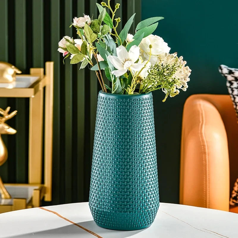 Plastic Cylinder Vase in Teal with flowers inside