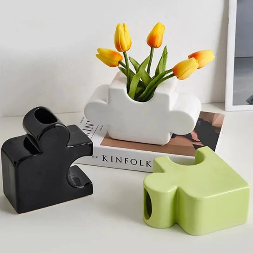 Three Puzzle Vases with tulips inside on a white surface