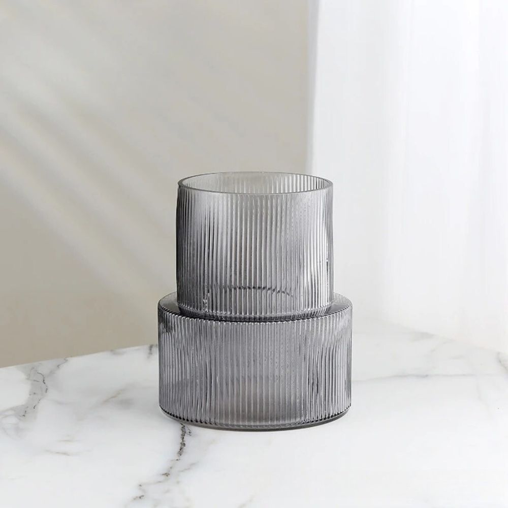 Short Cylinder Vase in dark gray on a white marble table