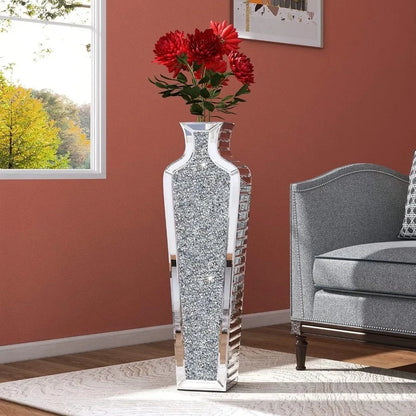 Silver Floor Vase with red flowers inside on a white carpet