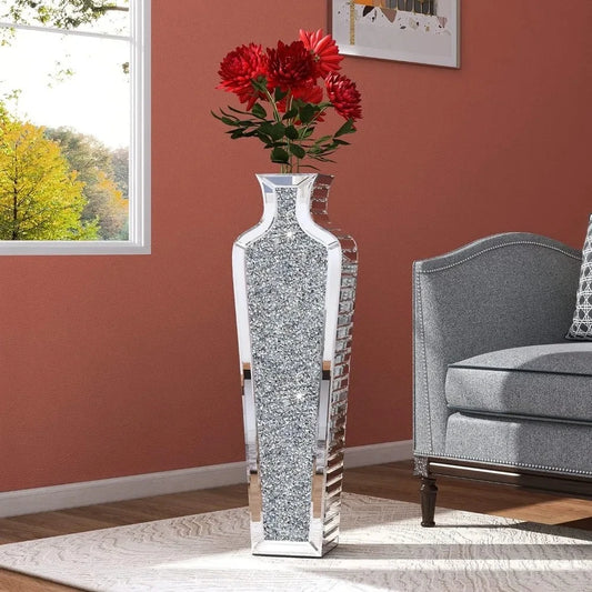 Silver Floor Vase with red flowers inside on a white carpet