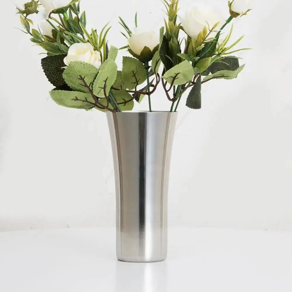 Silver Metal Vase With Plants and Flowers Inside 