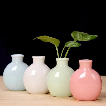 Four Small Bud Vases in Light Blue, White, Light Green and Pink