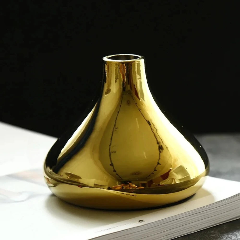 Small Gold Vase on a white surface 