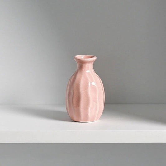 Small Pink Vase on a white table in front of a white wall