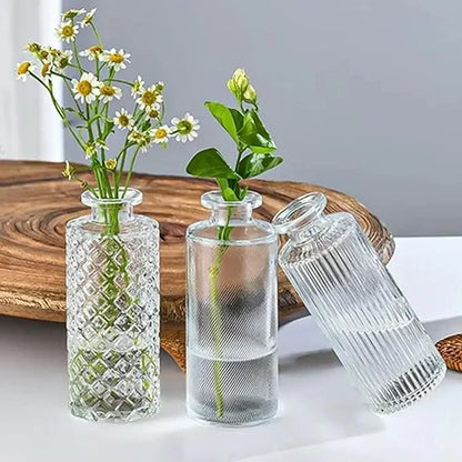 Three vases from a Small Vase Set on a white table in front of wood