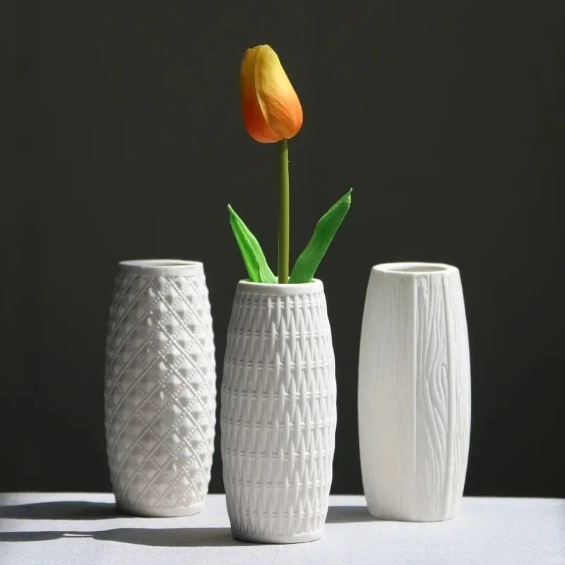 Three Small White Vases on a white surface