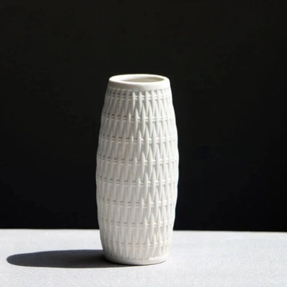 Small White Vase with bamboo weaving on a white surface