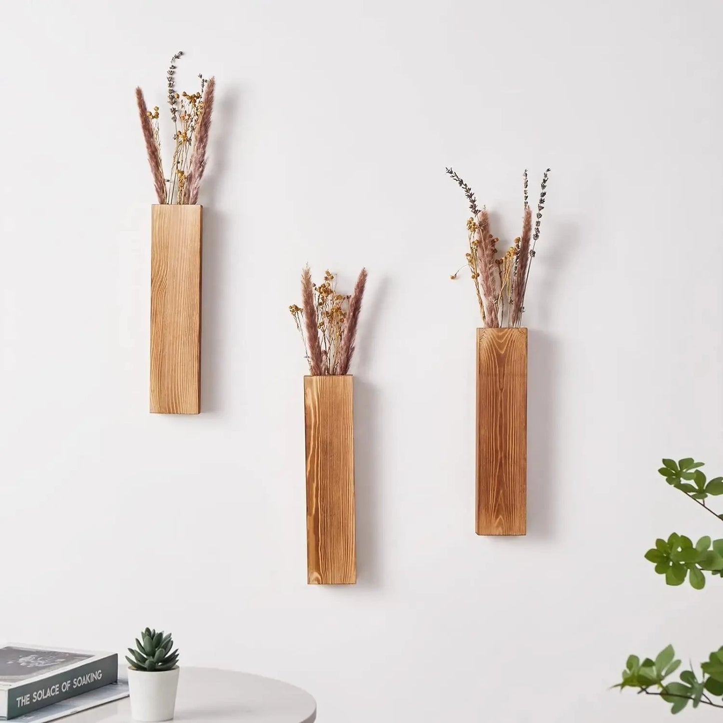 Three Wall Vases with dried fern inside installed on a white wall