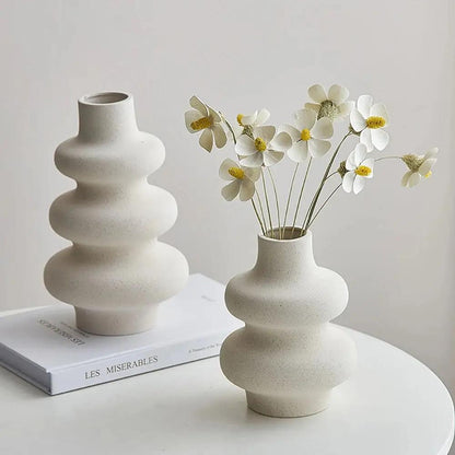 Two White Bud Vases with white flowers inside