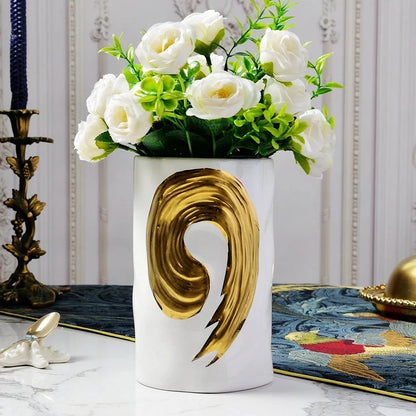 White Cylinder Vase with white flowers inside on a white marble table