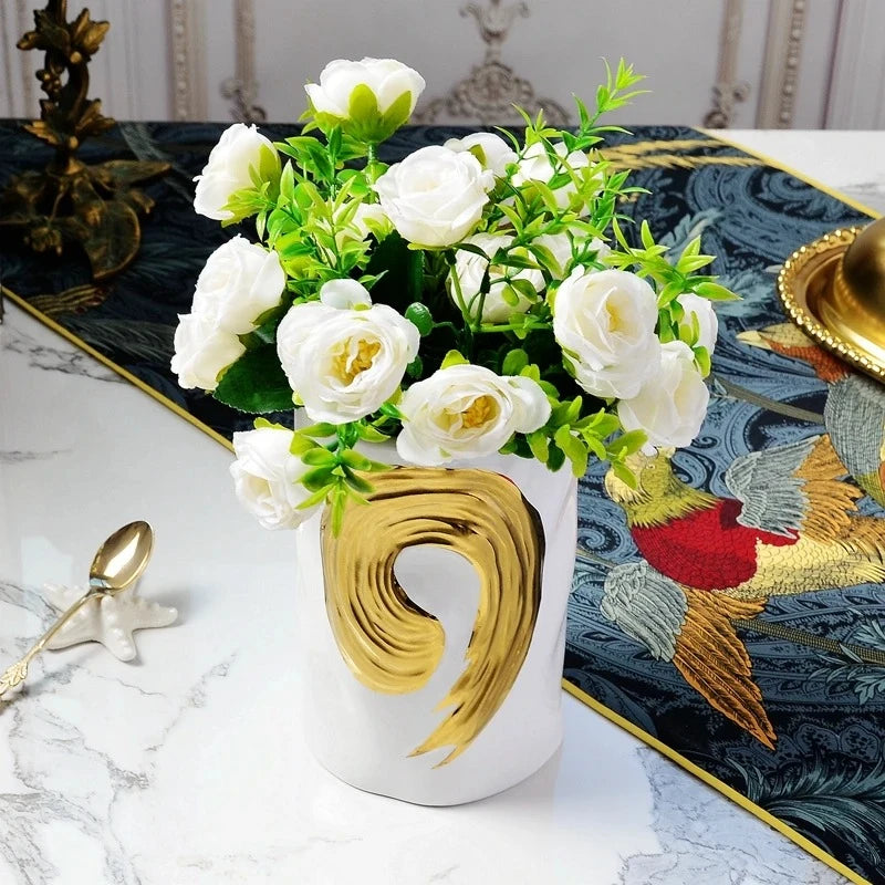 White Cylinder Vase with white roses inside on a white marble table