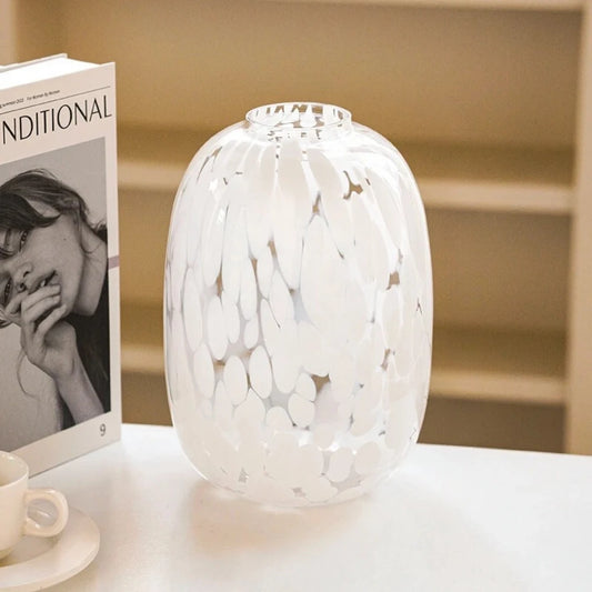 Medium White Glass Vase on a white surface next to a book