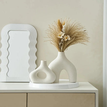 Two White Round Vases on a white tray next to a mirror