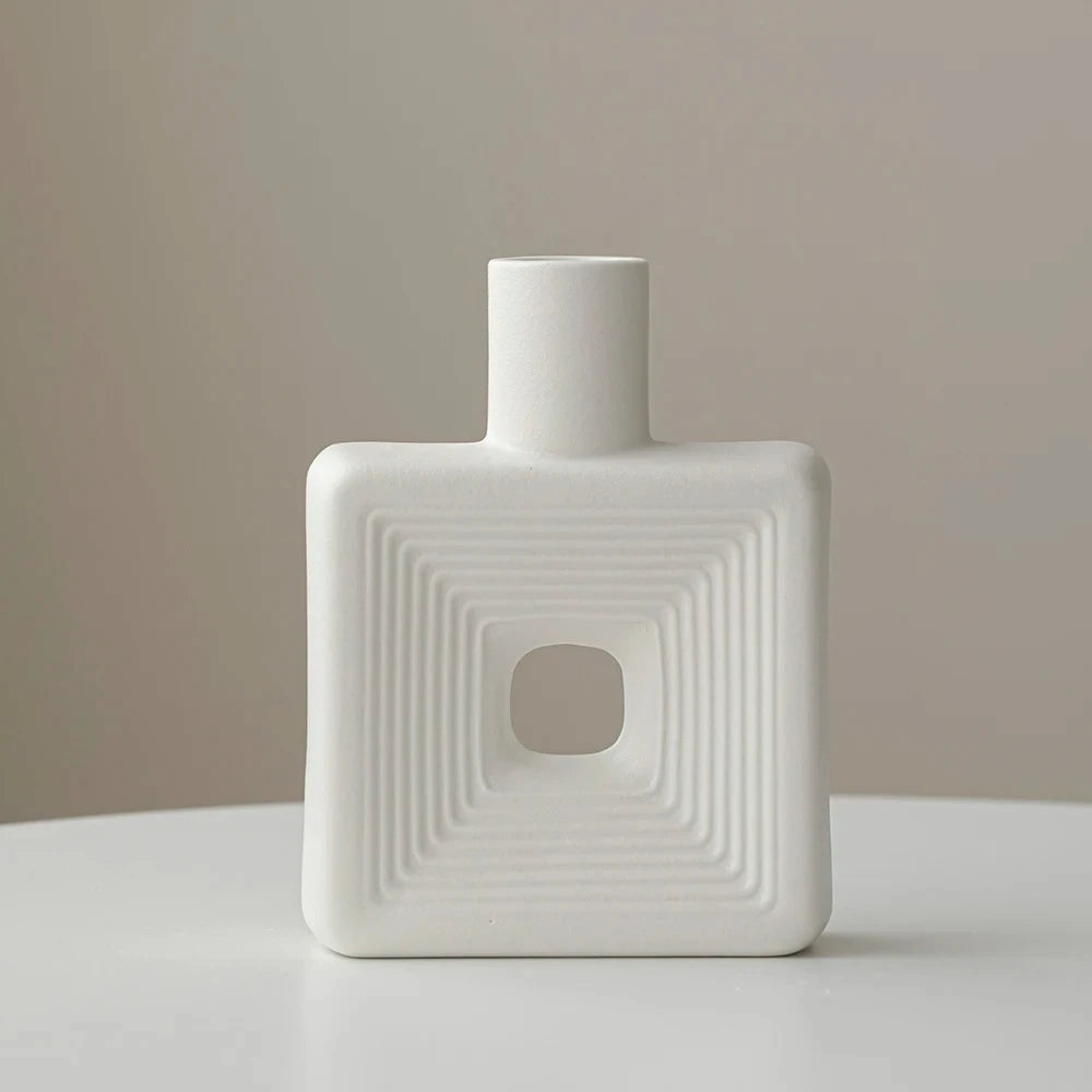 White Square Vase in front of a beige background on a white surface