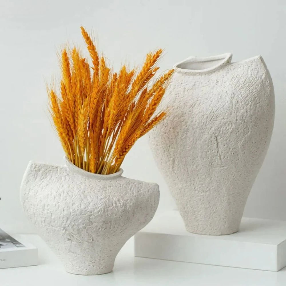 Two White Textured Vase on a white table with orange decoration inside