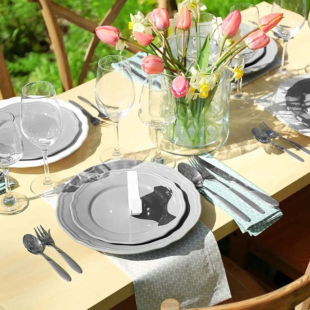 Wide Glass Cylinder Vase on a table with flowers inside next to cutlery and tableware