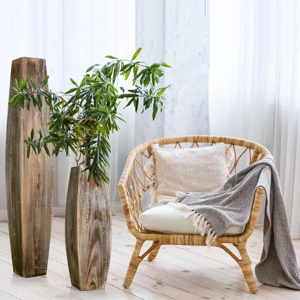 Two Wood Floor Vases next to a bamboo chair