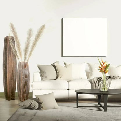 Two Wood Floor Vases standing next to a white couch