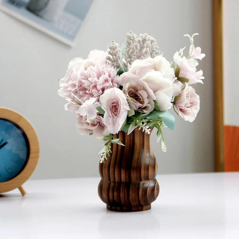 Wood Vase with roses inside on a white table