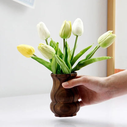 Person holding a Wood Vase with yellow tulips inside